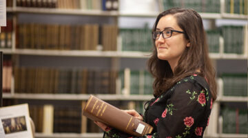 student holding book